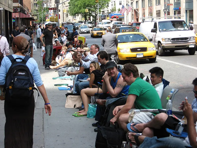 People waiting in lawn chairs outside an Apple Store in New York City to buy the first iPhone on launch day in 2007
